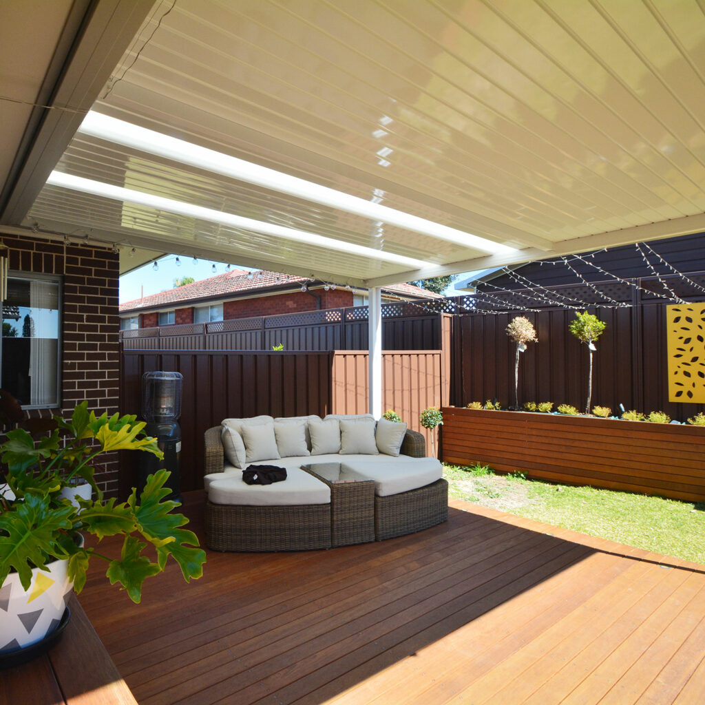 DIY attached flat roof patio with circular seating and plants