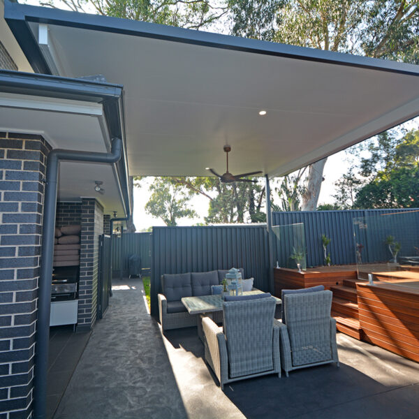 Stylish outdoor seating area under a DIY attached flyover flat roof patio.