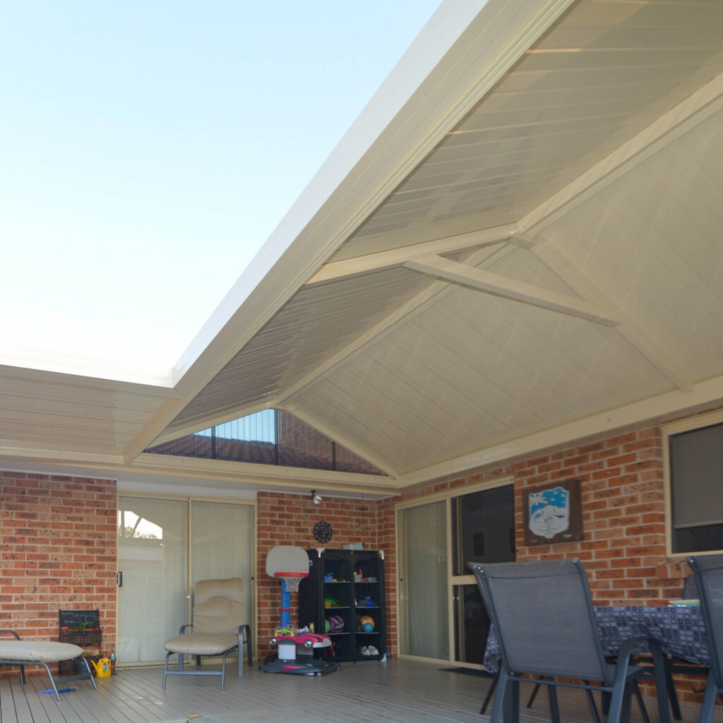 DIY attached gable roof patio/pergola area with shade and seating.