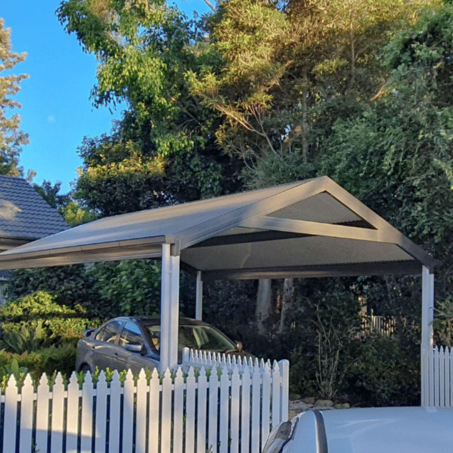 Car parked under a metal DIY freestanding gable roof carport