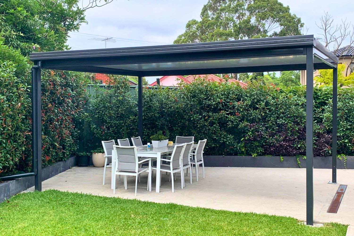 Outdoor dining area under a shaded pergola