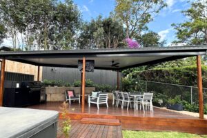 Outdoor patio area with seating and BBQ grill.