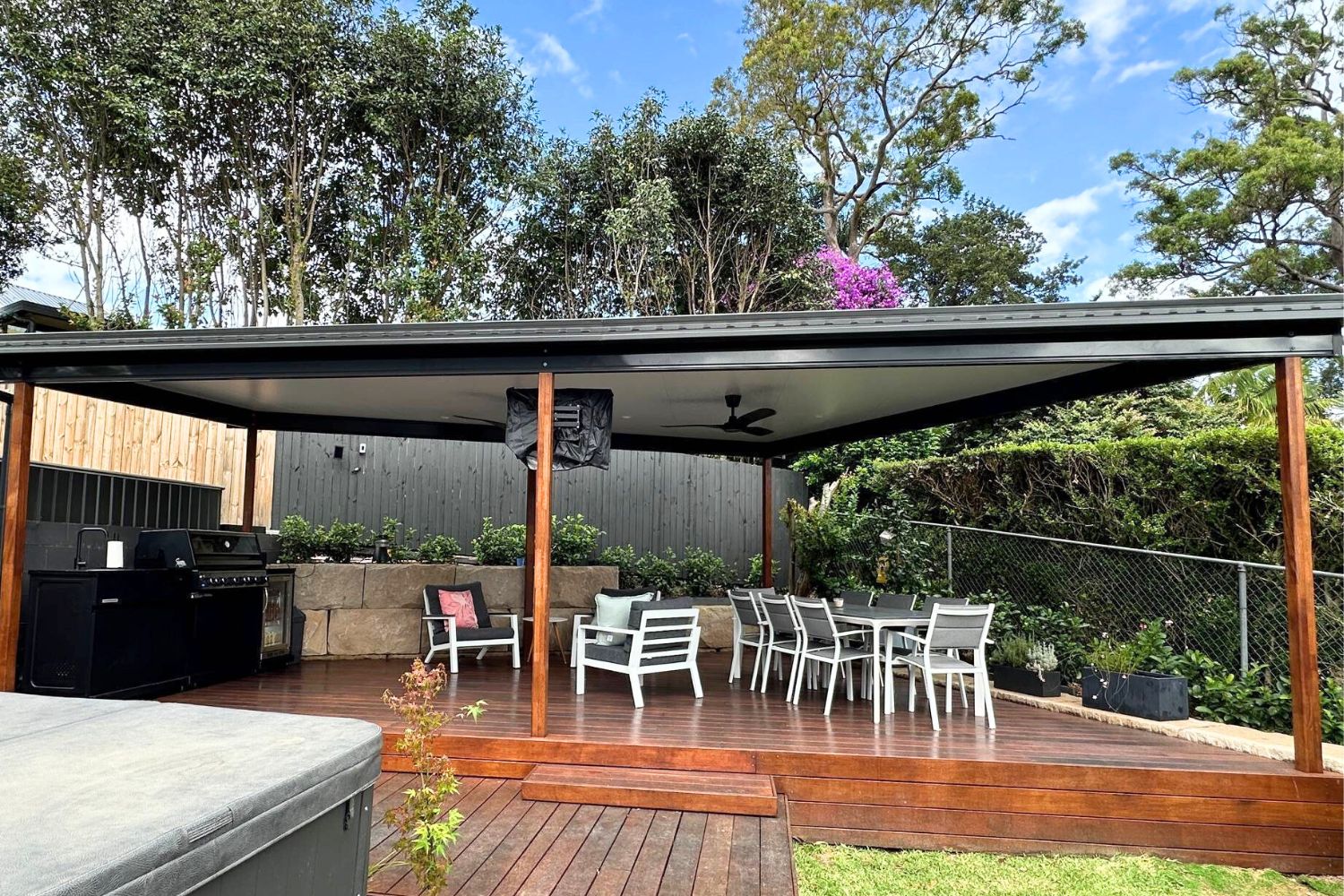 Outdoor patio area with seating and BBQ grill.